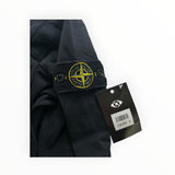 Secondstore black Stone Island crewneck sweatshirt sleeve with iconic yellow and green compass patch and price tag