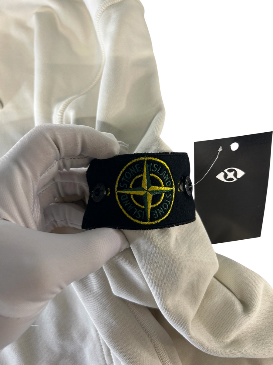 Secondstore Stone Island cream cotton hooded sweatshirt featuring the iconic removable compass badge on the sleeve.