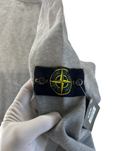 Secondstore grey cotton fleece sweatshirt featuring the iconic detachable Stone Island compass patch on the sleeve.