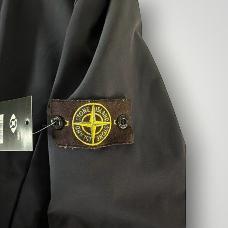 Secondstore Stone Island black soft shell jacket sleeve featuring the iconic yellow and green compass logo patch