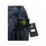 Secondstore navy Stone Island cotton sweatshirt sleeve with signature yellow and green compass badge and price tag