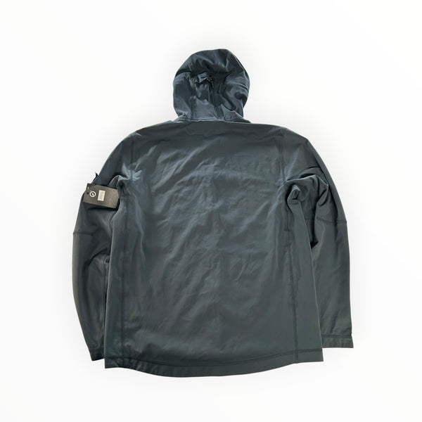 Back view of a Secondstore Stone Island light soft shell hooded jacket in dark grey with a sleeve compass badge.