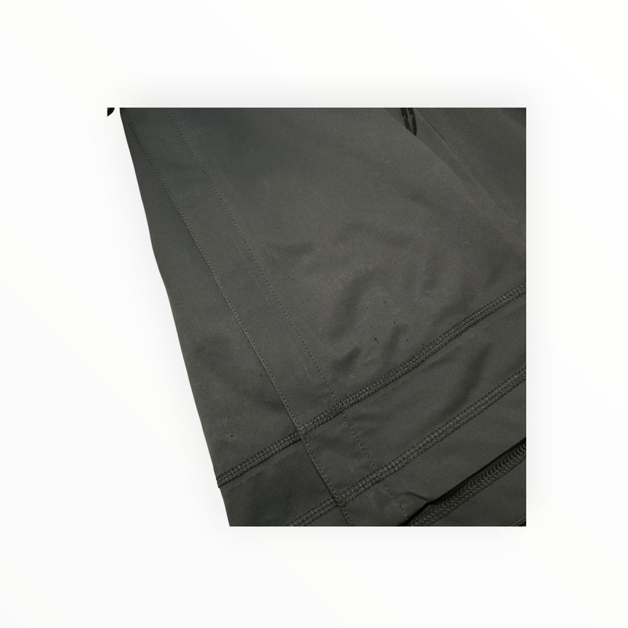 Close-up of the black technical soft shell fabric on a Secondstore Stone Island hooded jacket with reinforced seams.