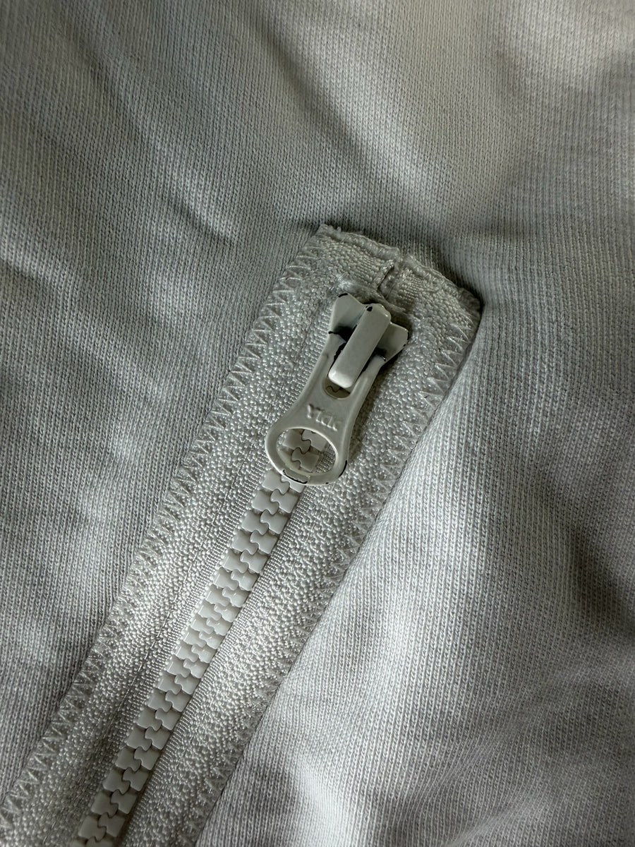 Gros plan sur la fermeture éclair YKK blanche d'un sweat à capuche Secondstore en coton blanc cassé