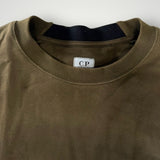 Gros plan sur le col rond en coton kaki d'un sweat-shirt Secondstore C.P. Company avec étiquette intérieure