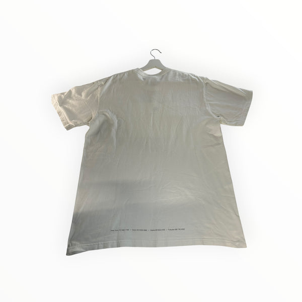 Secondstore white cotton short sleeve t-shirt with back hem typography listing global store phone numbers